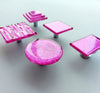 Fired glass cabinet knobs in bright pink made of round, square and rectangular glass pieces attached over a metal base. Slightly textured glass furniture handles with rounded edges.